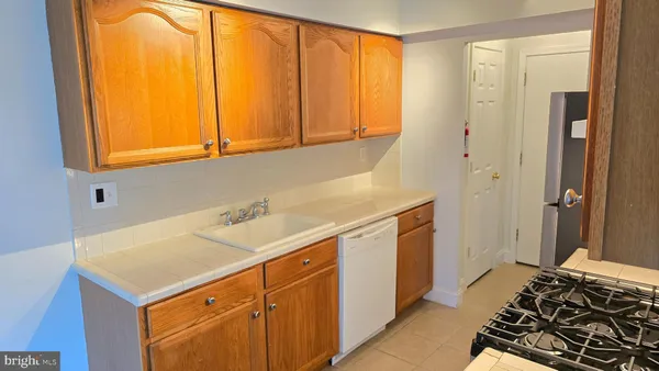a kitchen with stainless steel appliances a stove a refrigerator and cabinets