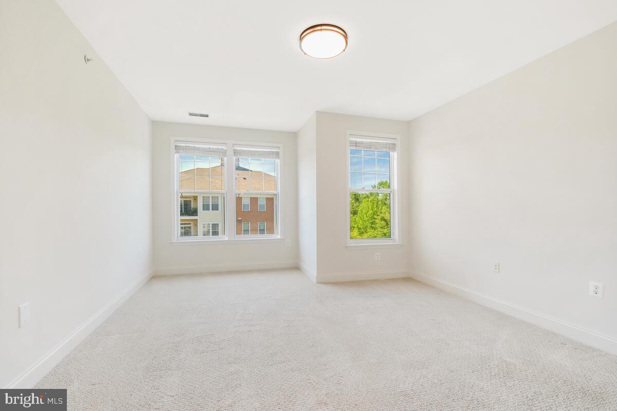 130 Chevy Chase Street, Unit 404 Gaithersburg, MD 20878 - Photo 12 of 39 an empty room with windows