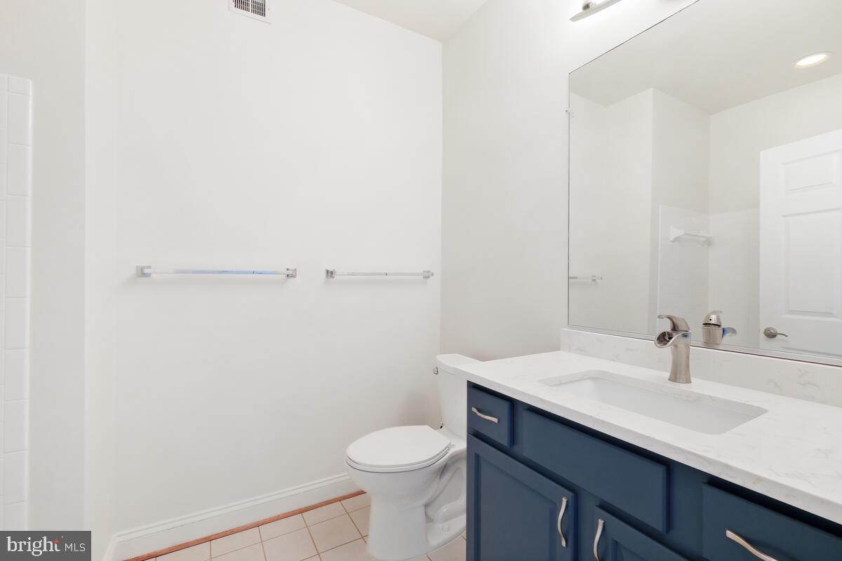 130 Chevy Chase Street, Unit 404 Gaithersburg, MD 20878 - Photo 13 of 39 a bathroom with a sink a toilet and vanity