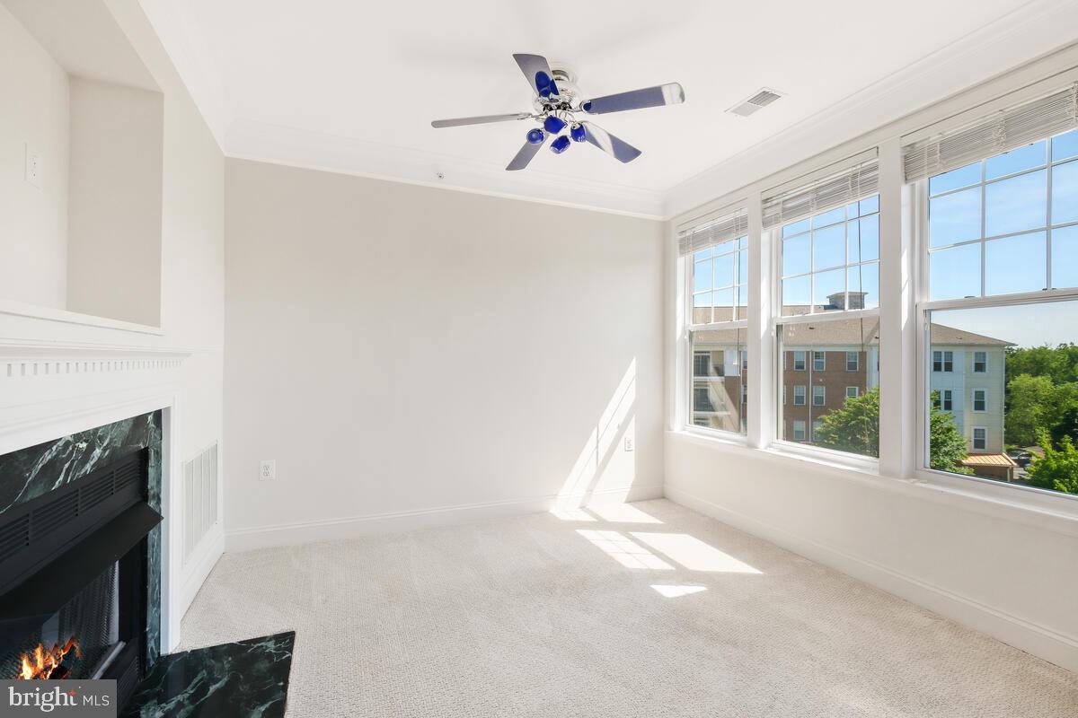 130 Chevy Chase Street, Unit 404 Gaithersburg, MD 20878 - Photo 15 of 39 a view of an empty room with a fireplace