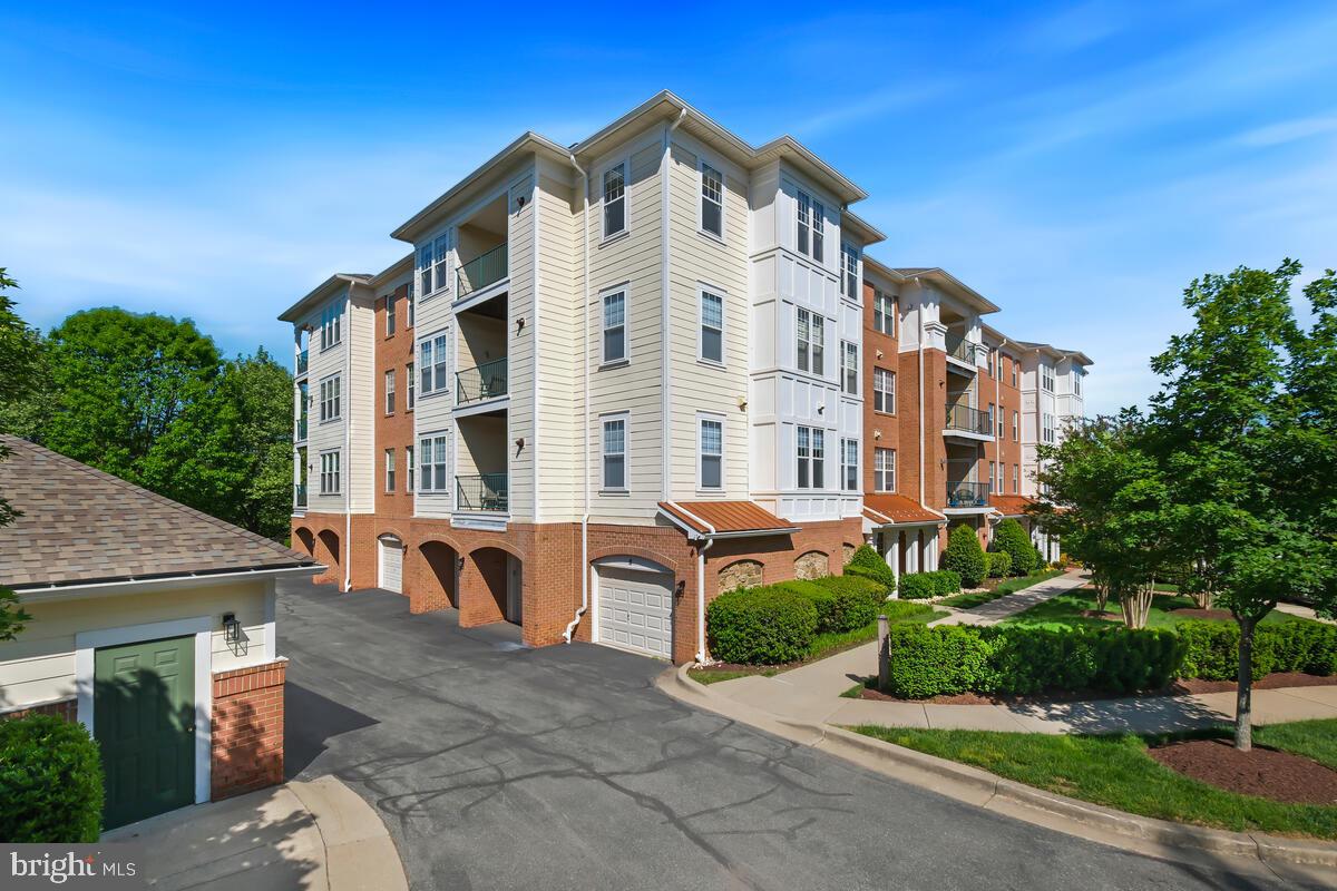130 Chevy Chase Street, Unit 404 Gaithersburg, MD 20878 - Photo 2 of 39 a view of a building with a bench in front of it