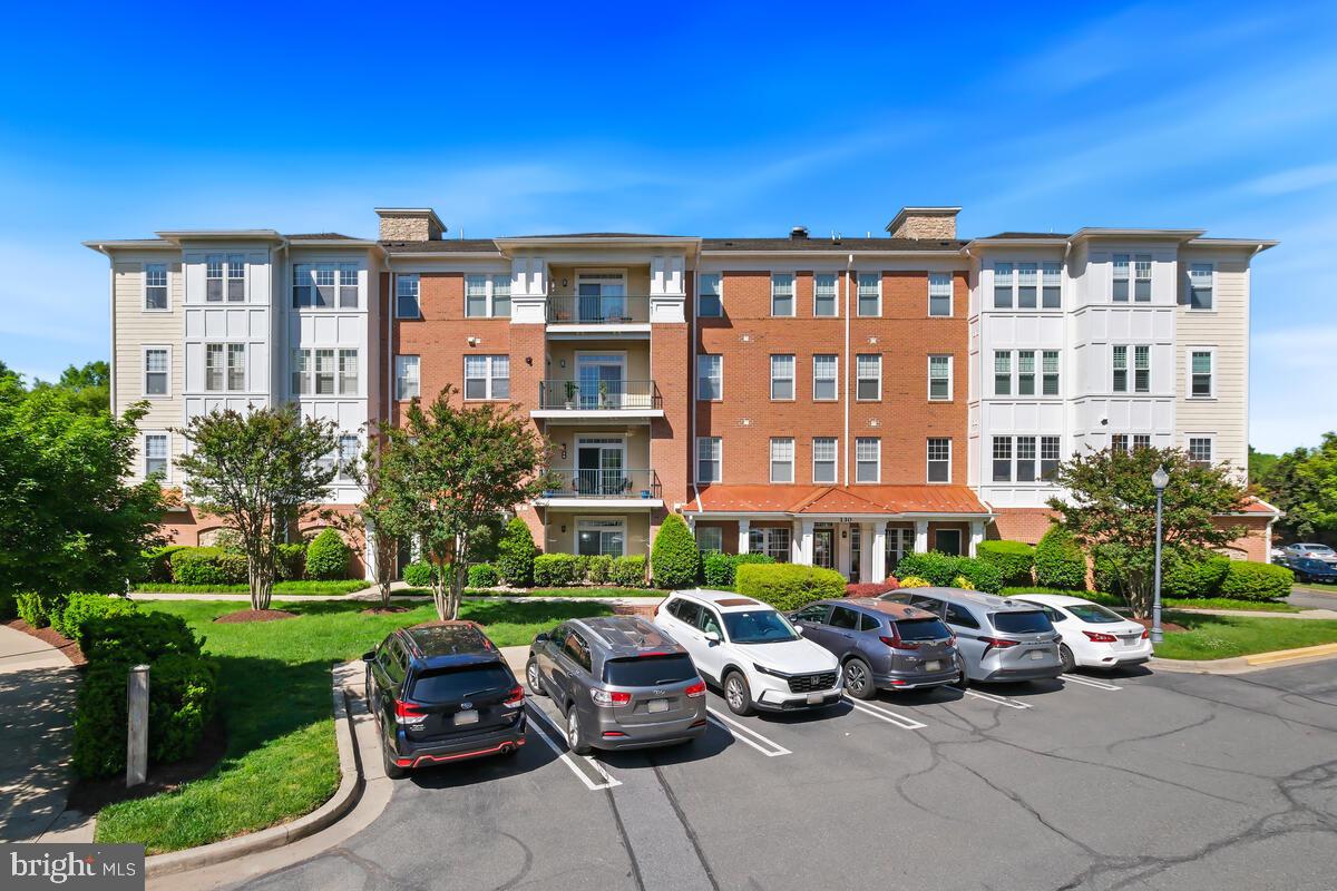 130 Chevy Chase Street, Unit 404 Gaithersburg, MD 20878 - Photo 3 of 39 a view of a building with a garden and patio