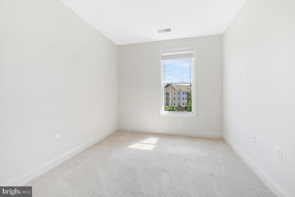 130 Chevy Chase Street, Unit 404 Gaithersburg, MD 20878 - Photo 8 of 39 an empty room with windows