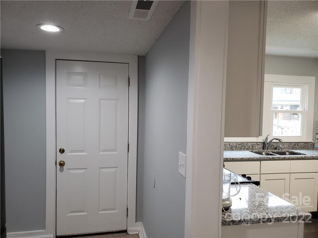 473 Liberty Drive Southwest Concord, NC 28027 - Photo 11 of 19 a bathroom with a granite countertop sink and a mirror