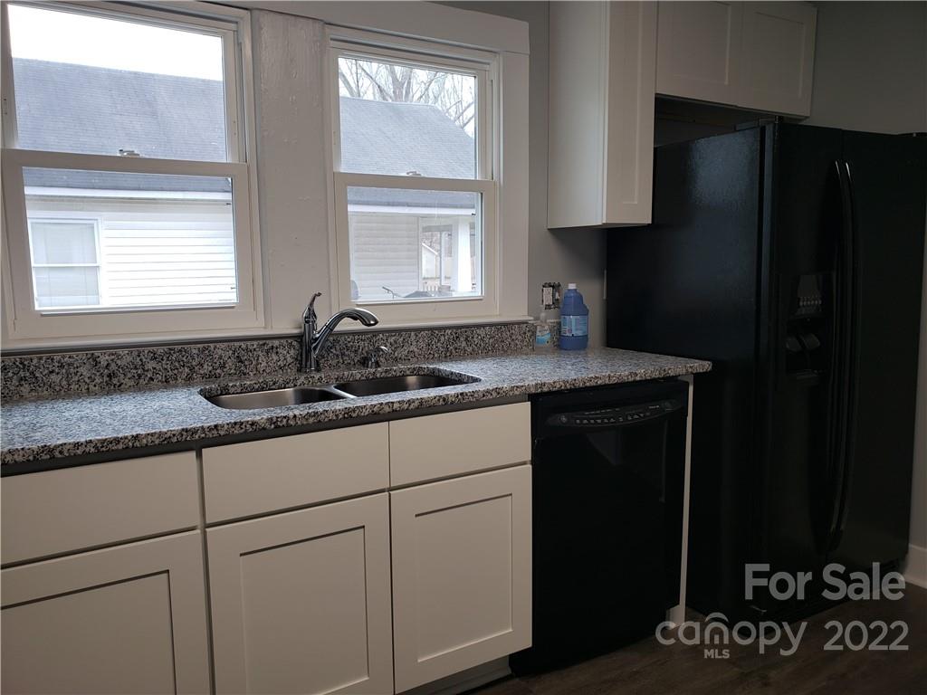 473 Liberty Drive Southwest Concord, NC 28027 - Photo 16 of 19 a kitchen with a sink and a refrigerator