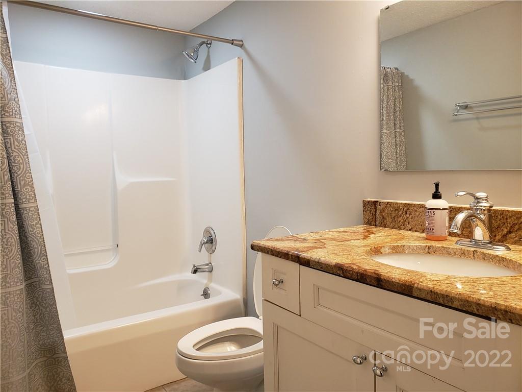 473 Liberty Drive Southwest Concord, NC 28027 - Photo 9 of 19 a bathroom with a granite countertop sink toilet and shower