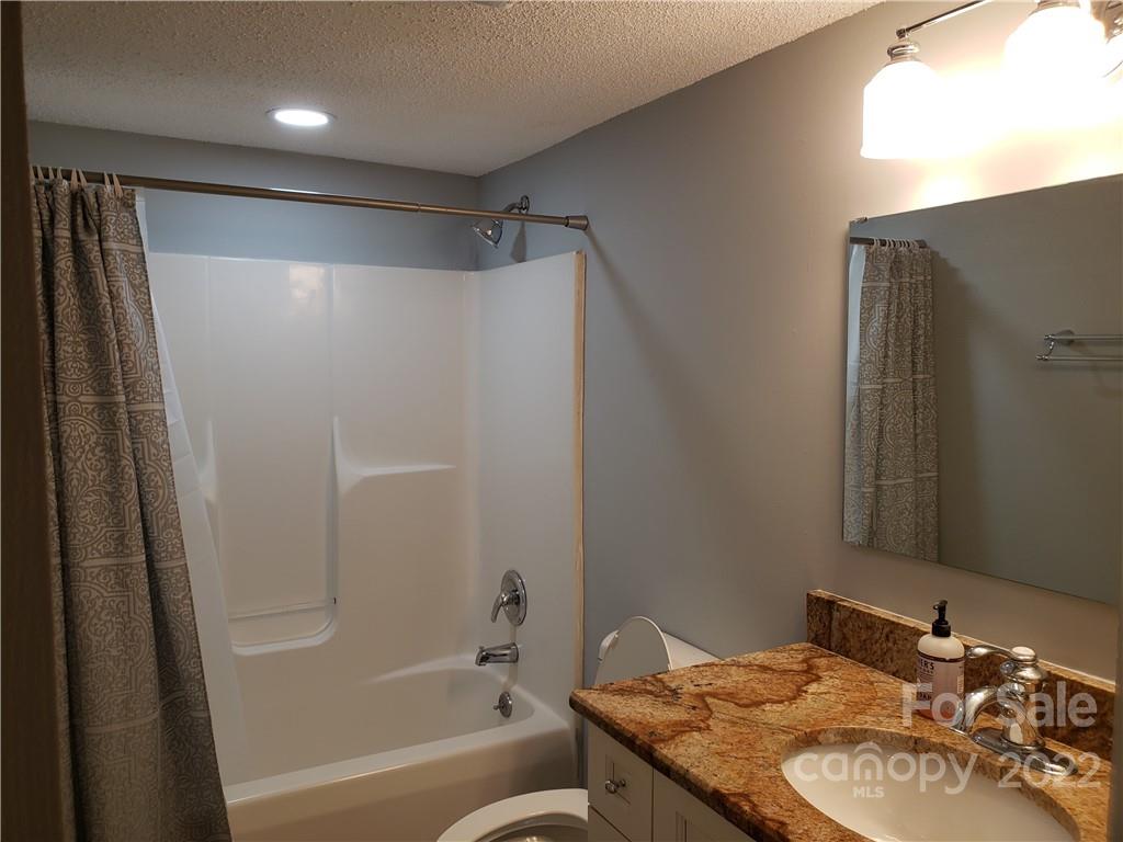 473 Liberty Drive Southwest Concord, NC 28027 - Photo 10 of 19 a bathroom with a granite countertop sink toilet and shower