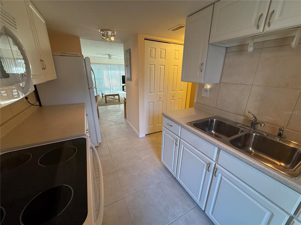 7701 Starkey Road, Unit 703 Seminole, FL 33777 - Photo 11 of 23 a kitchen with a sink and refrigerator