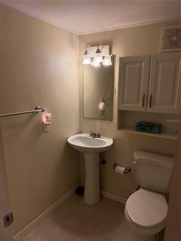 7701 Starkey Road, Unit 703 Seminole, FL 33777 - Photo 14 of 23 a bathroom with a toilet sink and mirror