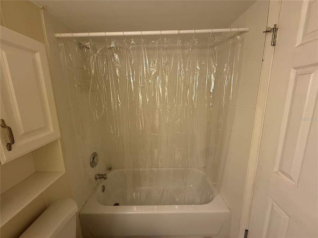 7701 Starkey Road, Unit 703 Seminole, FL 33777 - Photo 15 of 23 a bathroom with a bathtub and a shower