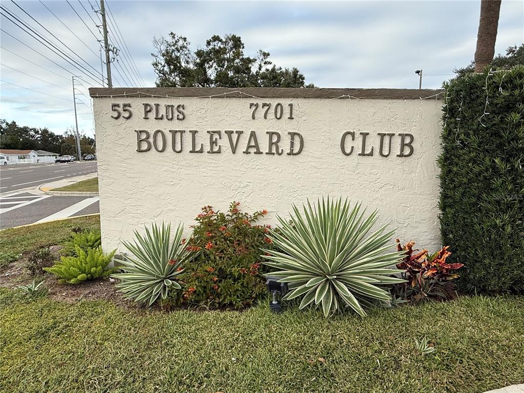 7701 Starkey Road, Unit 703 Seminole, FL 33777 - Photo 21 of 23 a sign on a street next to a yard