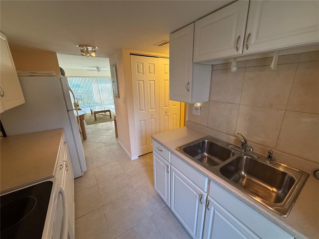 7701 Starkey Road, Unit 703 Seminole, FL 33777 - Photo 3 of 23 a kitchen that has a sink and a stove