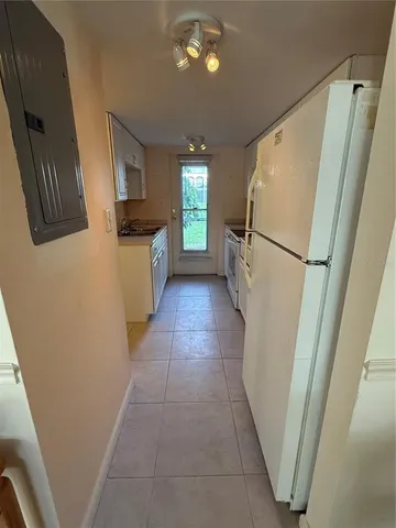 a kitchen with cabinets and appliances
