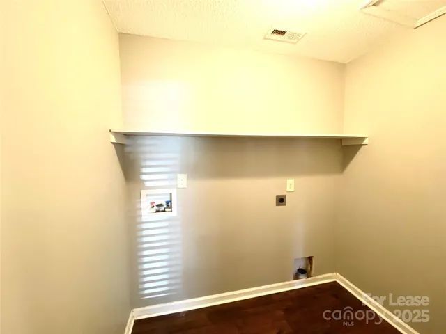 a view of a small space with wooden floor