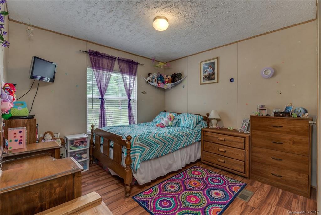 230 Cane Creek Road Rutherfordton, NC 28139 - Photo 12 of 18 a bedroom with a bed and wooden floor