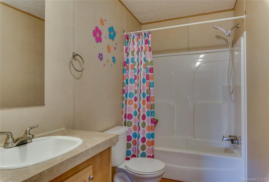230 Cane Creek Road Rutherfordton, NC 28139 - Photo 14 of 18 a bathroom with a sink toilet and shower
