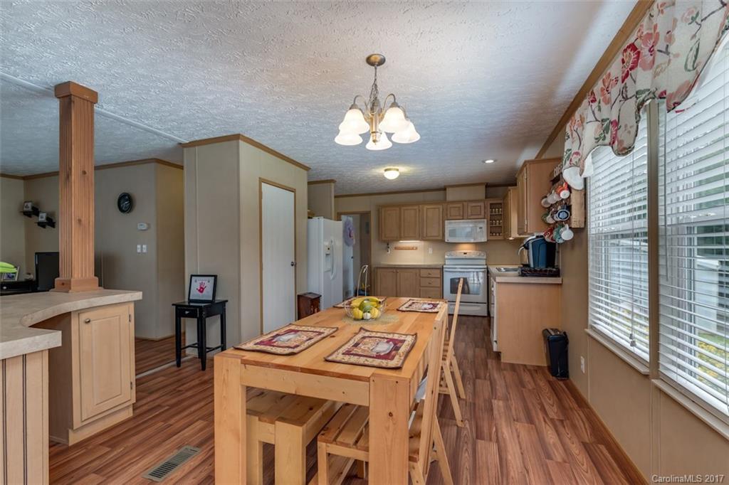 230 Cane Creek Road Rutherfordton, NC 28139 - Photo 3 of 18 a kitchen that has a lot of cabinets and wooden floor