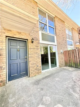 a view of a brick house with large windows