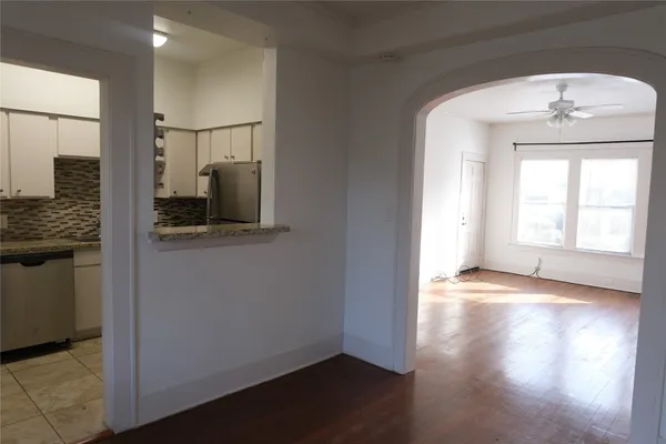 a view of hallway with a large mirror and a window