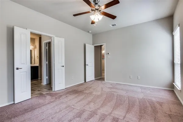 a view of a livingroom with a ceiling fan and window