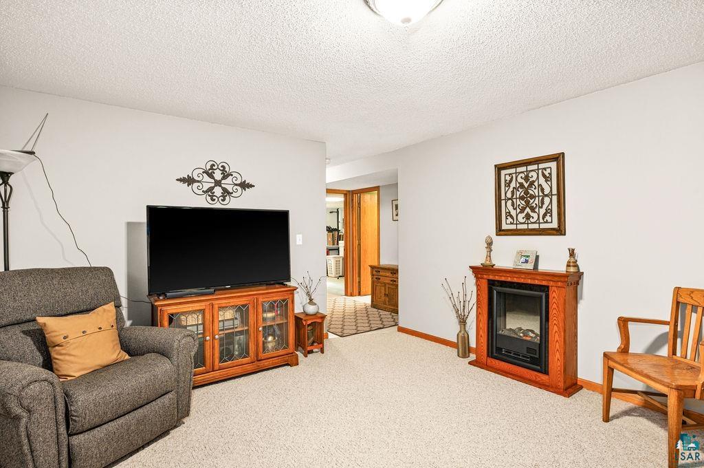 5279 Samuelson Road Duluth, MN 55811 - Photo 18 of 31 Tiled living room with a textured ceiling