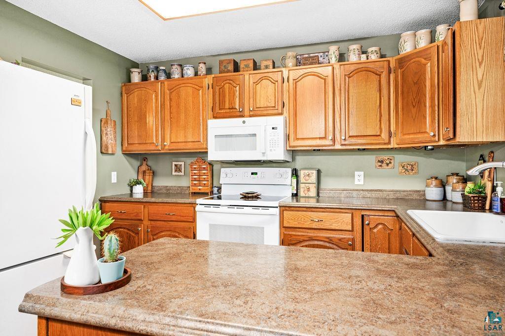 5279 Samuelson Road Duluth, MN 55811 - Photo 10 of 31 Kitchen featuring sink and white appliances