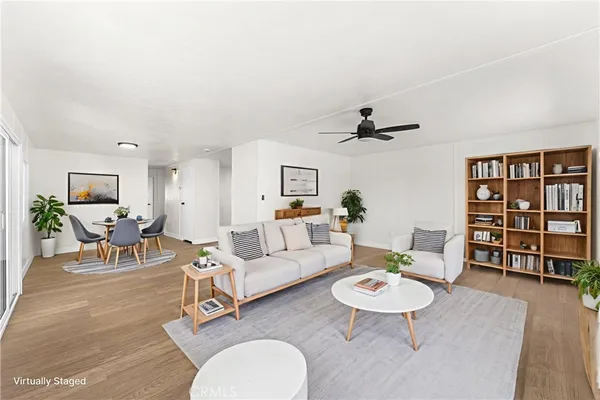 a living room with furniture and wooden floor
