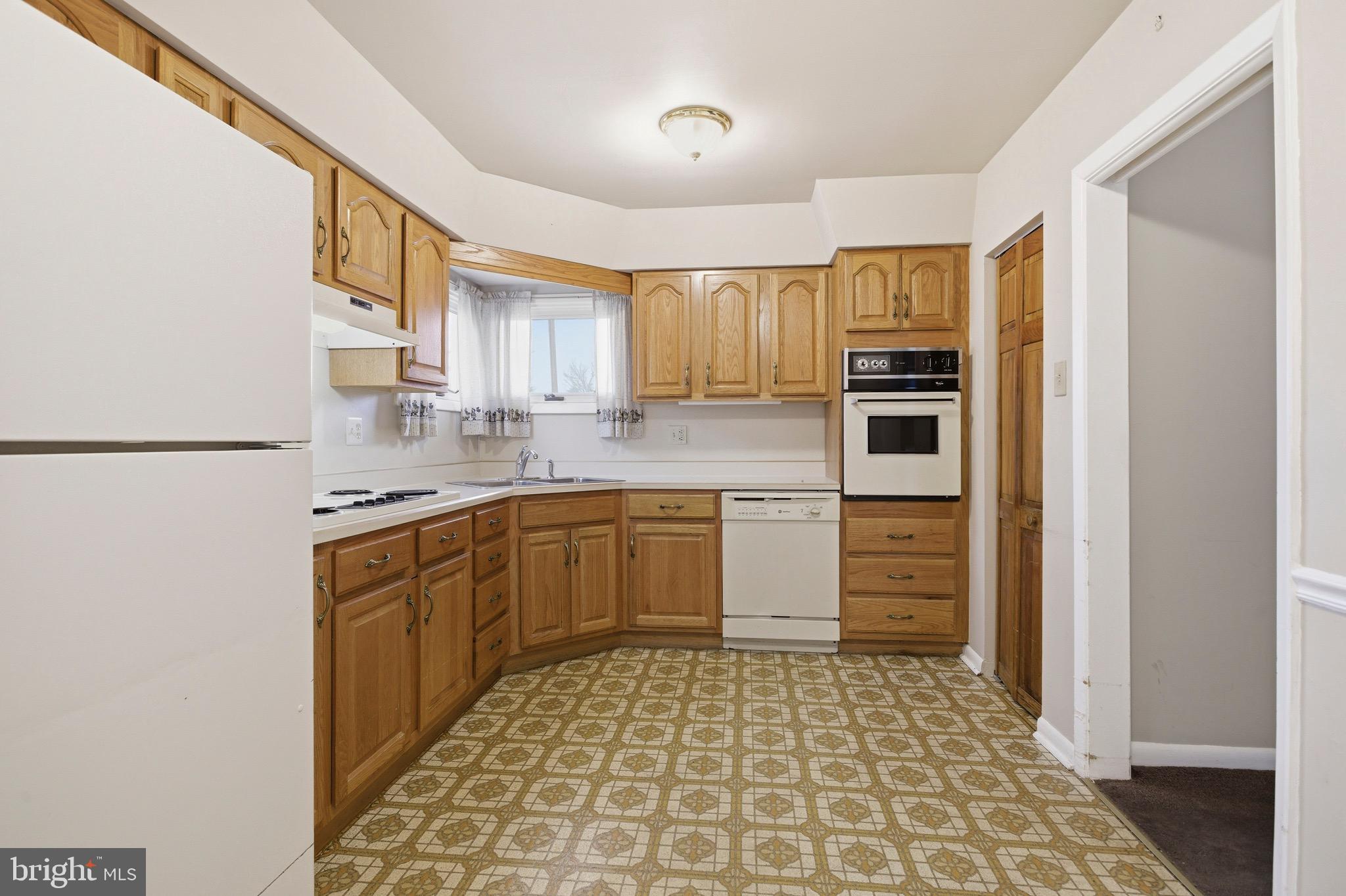 412 Foster Drive Springfield, PA 19064 - Photo 11 of 34 a kitchen with stainless steel appliances a refrigerator sink and microwave