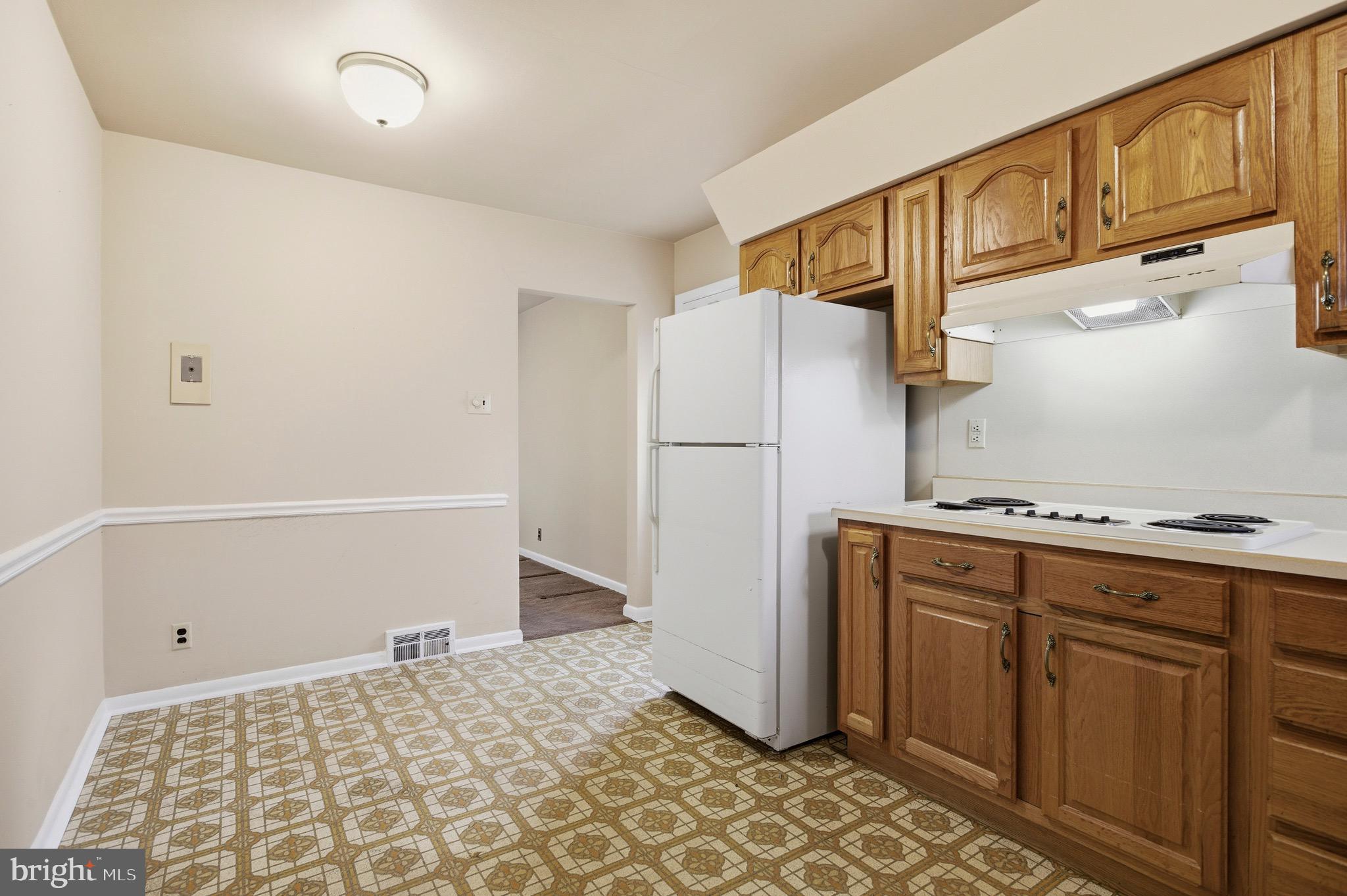 412 Foster Drive Springfield, PA 19064 - Photo 12 of 34 a kitchen with a refrigerator and a stove