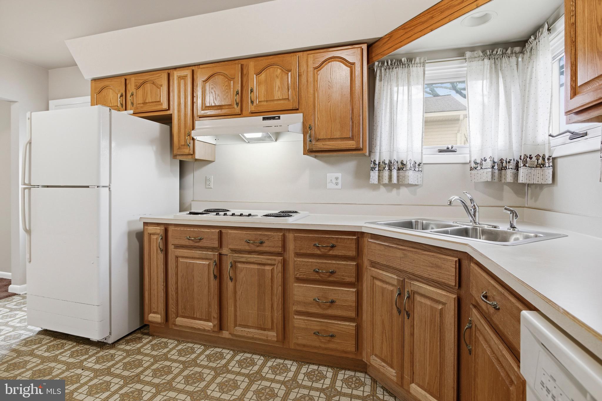 412 Foster Drive Springfield, PA 19064 - Photo 13 of 34 a kitchen with sink cabinets and window