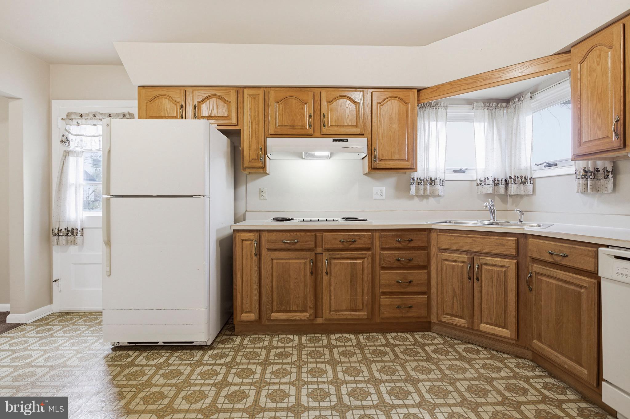 412 Foster Drive Springfield, PA 19064 - Photo 14 of 34 a kitchen with a refrigerator sink and cabinets