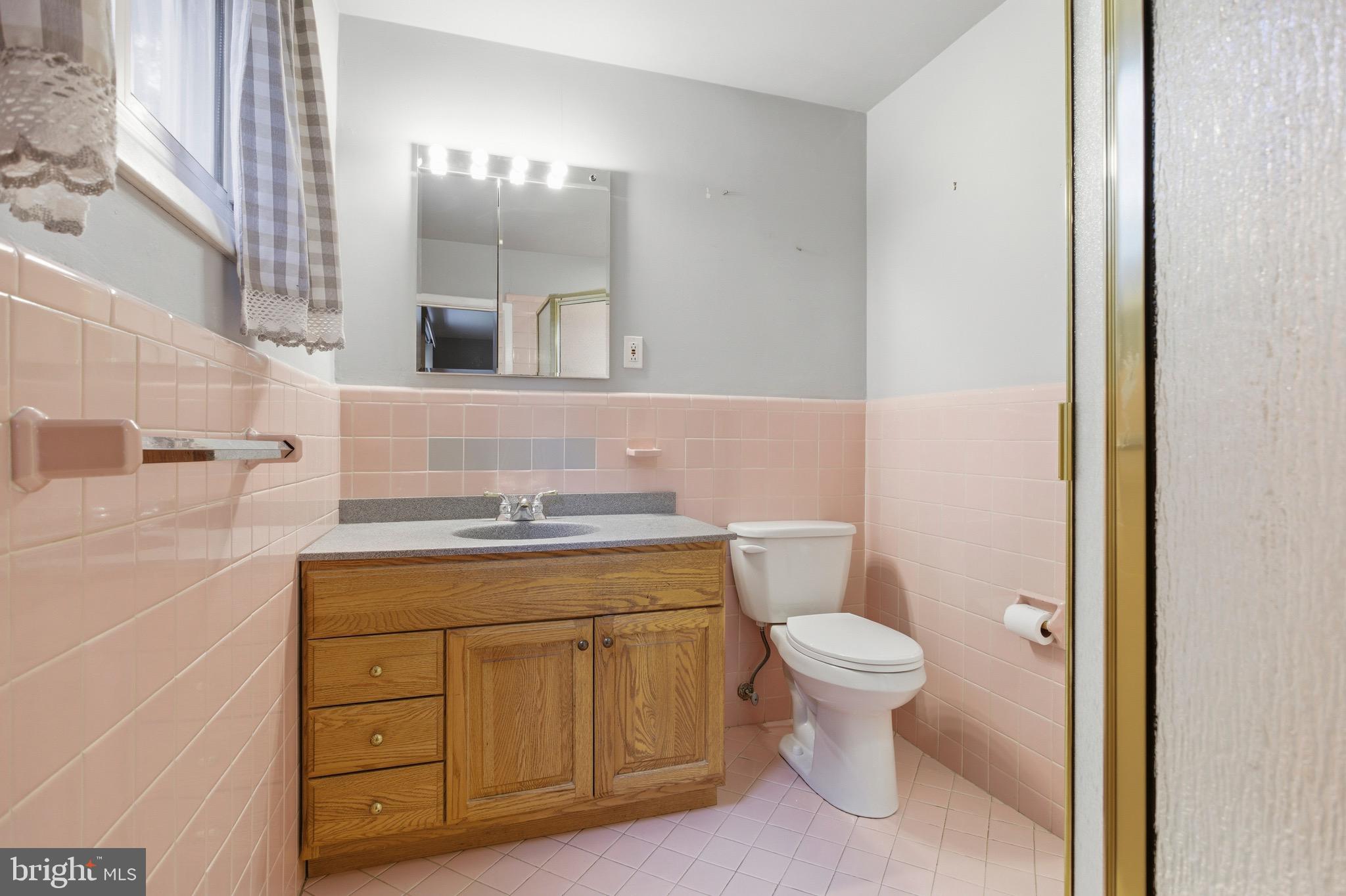 412 Foster Drive Springfield, PA 19064 - Photo 18 of 34 a bathroom with a granite countertop toilet sink and mirror