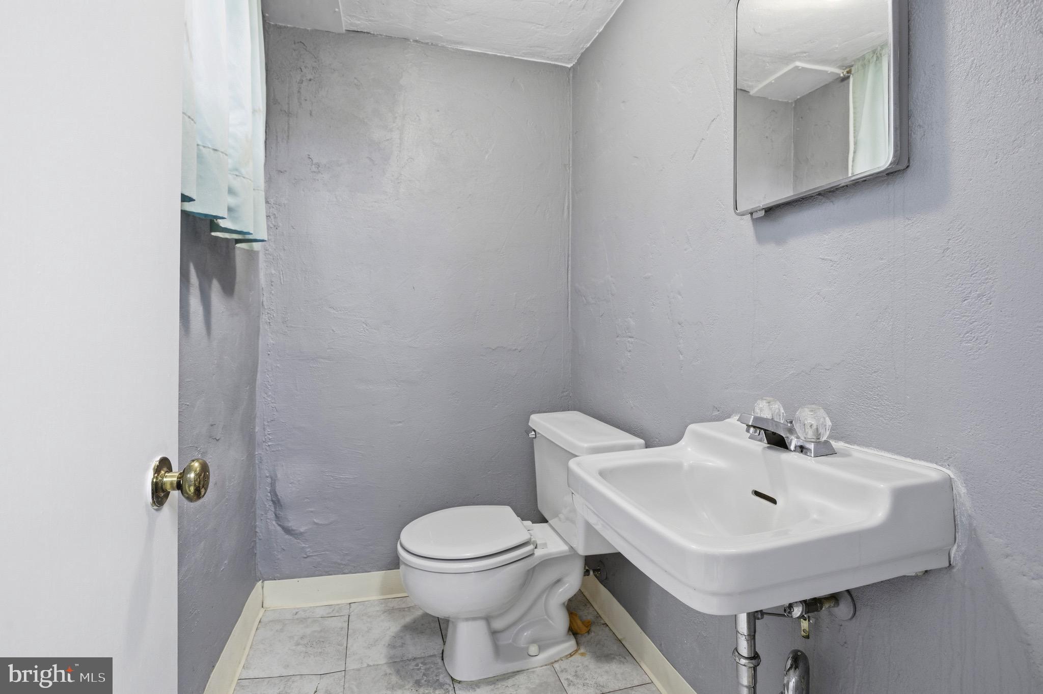 412 Foster Drive Springfield, PA 19064 - Photo 27 of 34 a white toilet sitting next to a bathroom sink