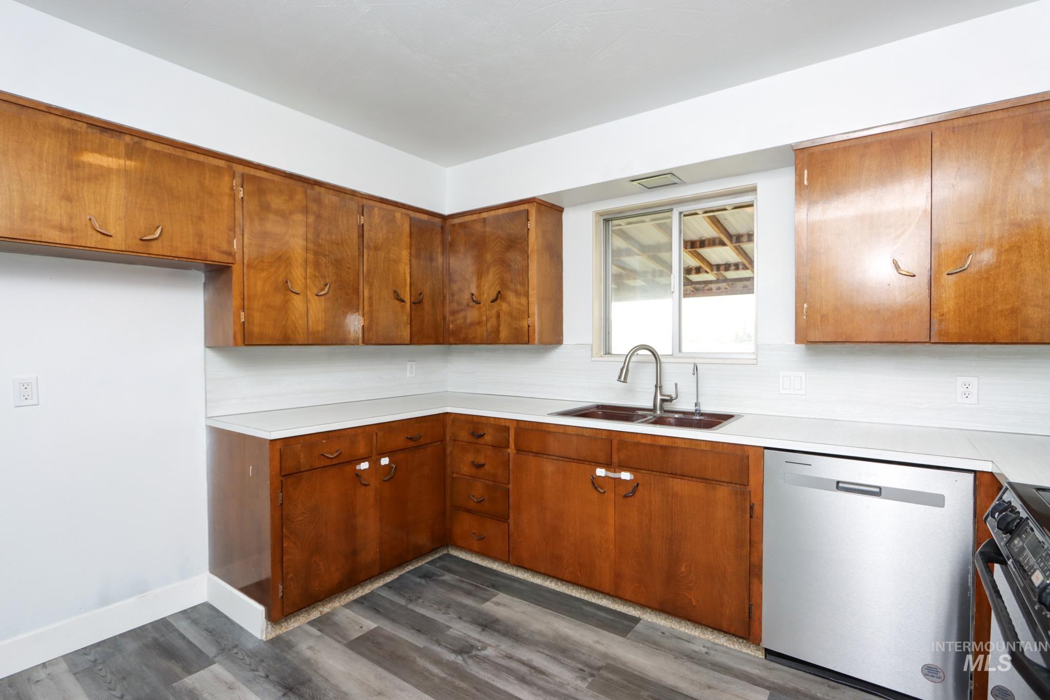 801 Thompson Avenue Nyssa, OR 97913 - Photo 13 of 46 Kitchen featuring wood cabinetry, white countertops, white subway tile backsplash, and wood-finish flooring