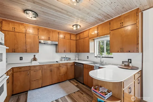 a kitchen with a sink a window and cabinets