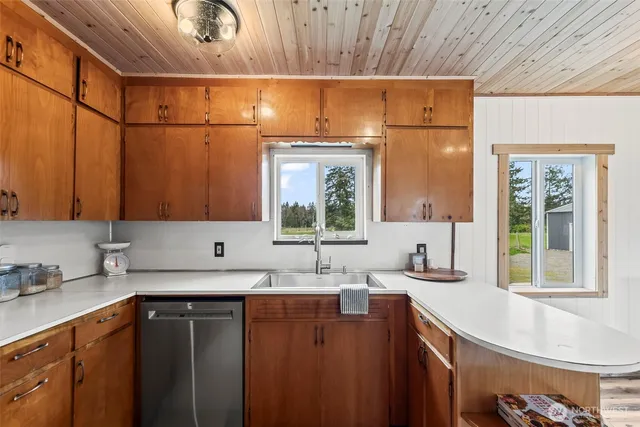 a large kitchen with a sink and cabinets