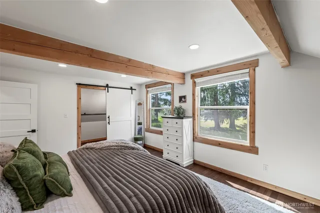 a bedroom with a large bed and a couch