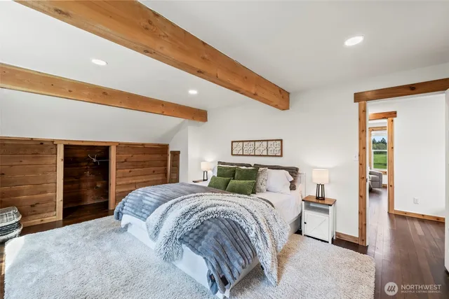 a bed sitting in a bedroom next to a window