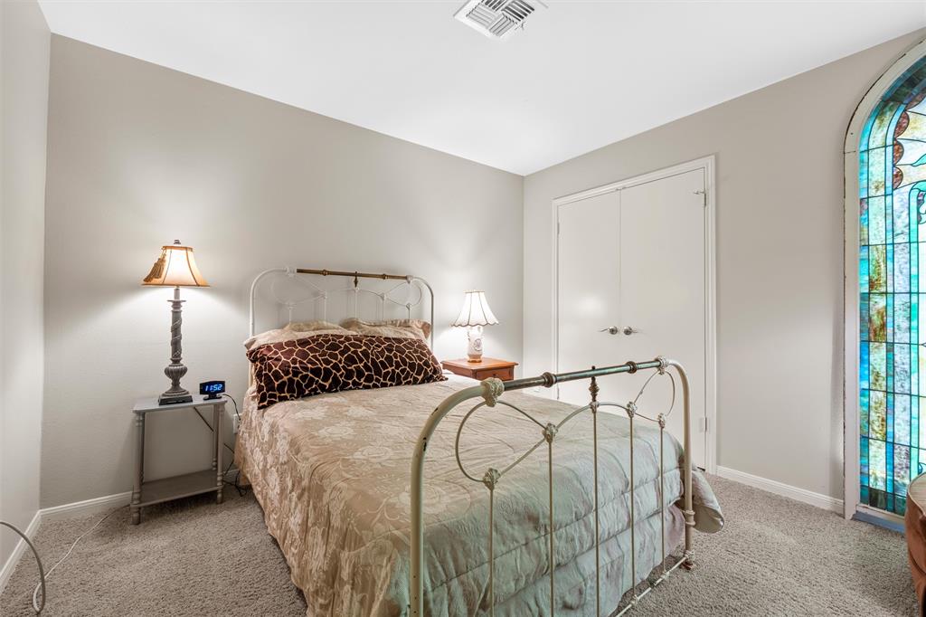 2901 Lake Shore Drive, Unit 405 Waco, TX 76708 - Photo 19 of 31 a bedroom with a bed and a window