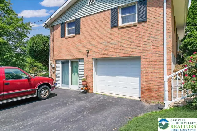 a front view of a house with parking space