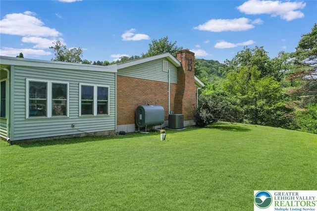 a backyard of a house with table and chairs