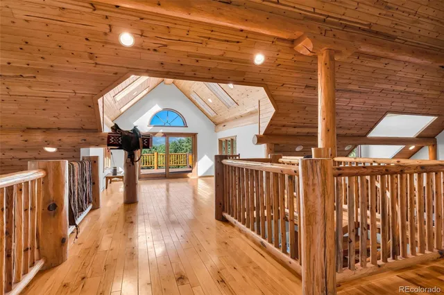 a view of a patio with wooden floor and iron stairs