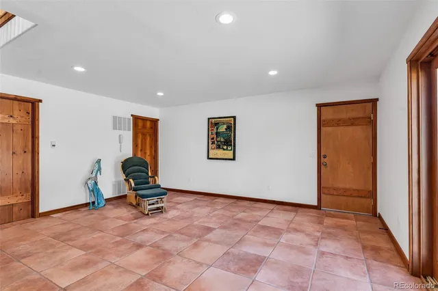 a view of a livingroom with chair and front door