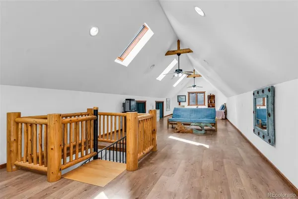 a living room with furniture stairs and a window