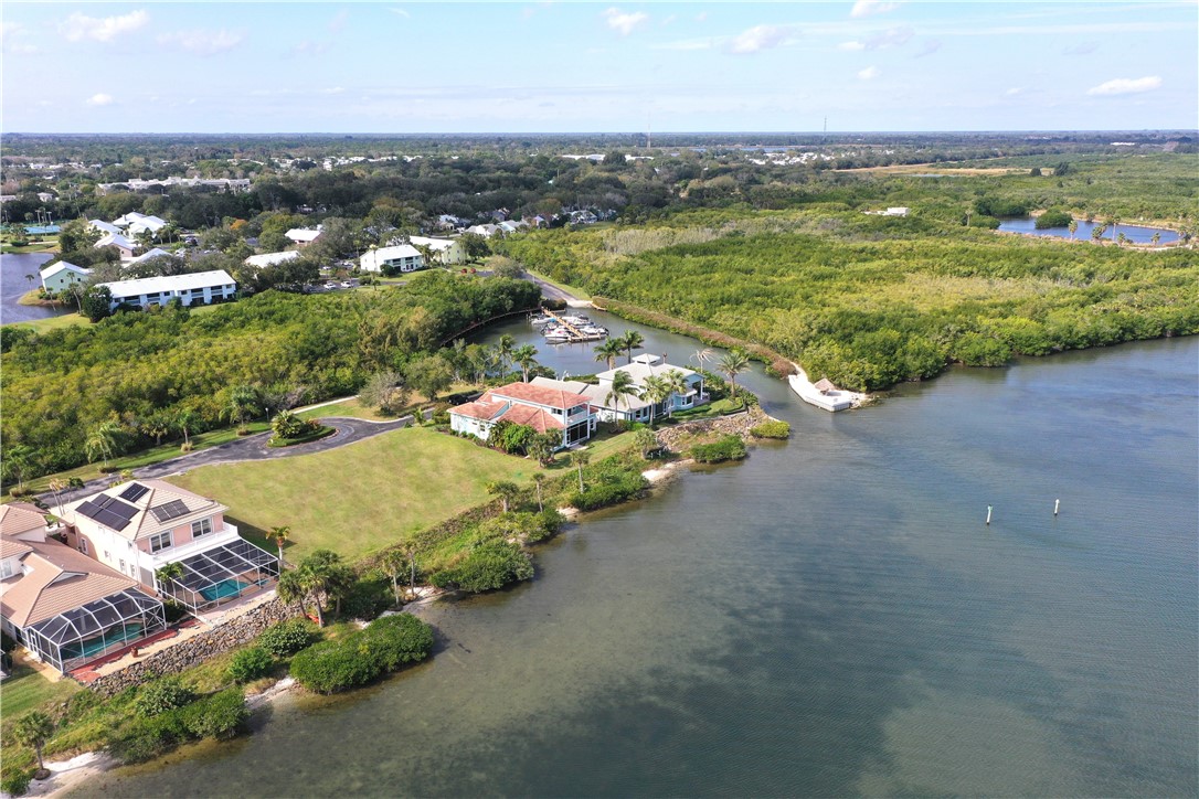9518 Riverside Drive Sebastian, FL 32958 - Photo 4 of 22 an aerial view of a house with a garden and lake view