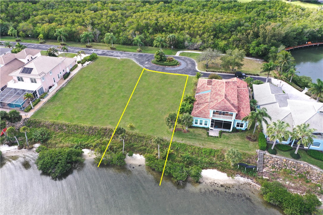 9518 Riverside Drive Sebastian, FL 32958 - Photo 5 of 22 an aerial view of a house with a garden and lake view