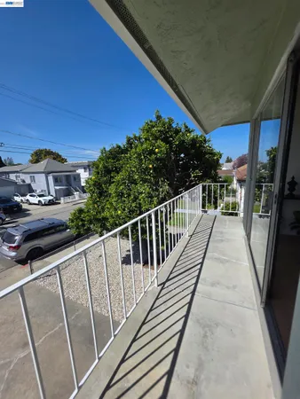 a view of a balcony with wooden floor