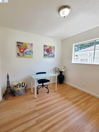 a view of a workspace with wooden floor