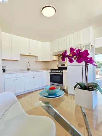 a kitchen with stainless steel appliances granite countertop a sink dishwasher and a stove with white countertops