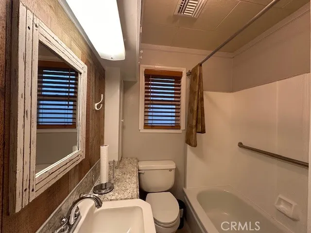 a bathroom with a toilet a sink and a window